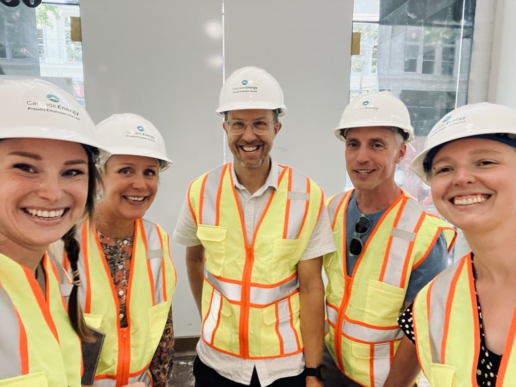 Cascade Energy team members posing in hard hats and reflective vests